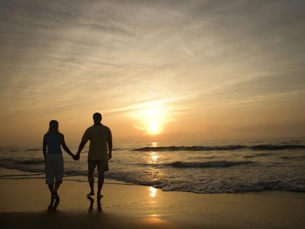 Romantic walk on the beach at sunset